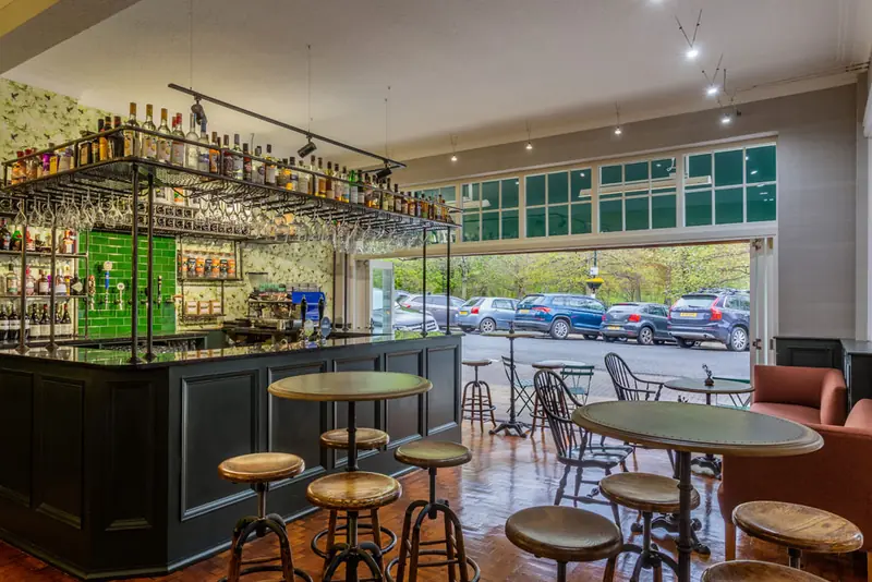 The bar with bi-folding doors open to the street
